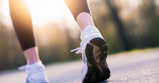 Running shoes on pavement representing athletic recovery and injury prevention
